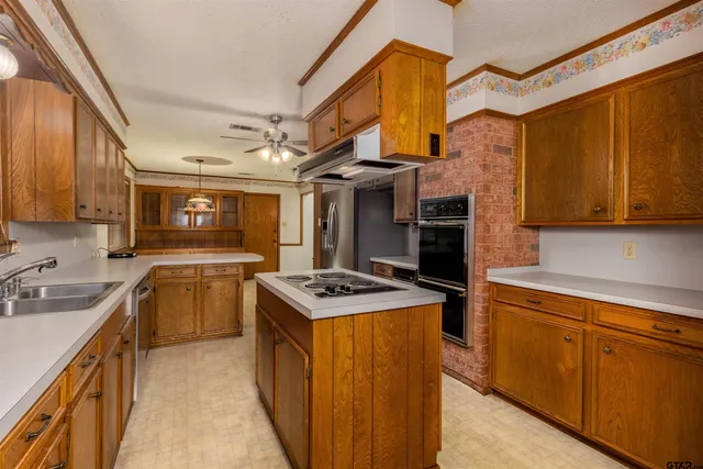 a kitchen with a stove top oven sink and cabinets