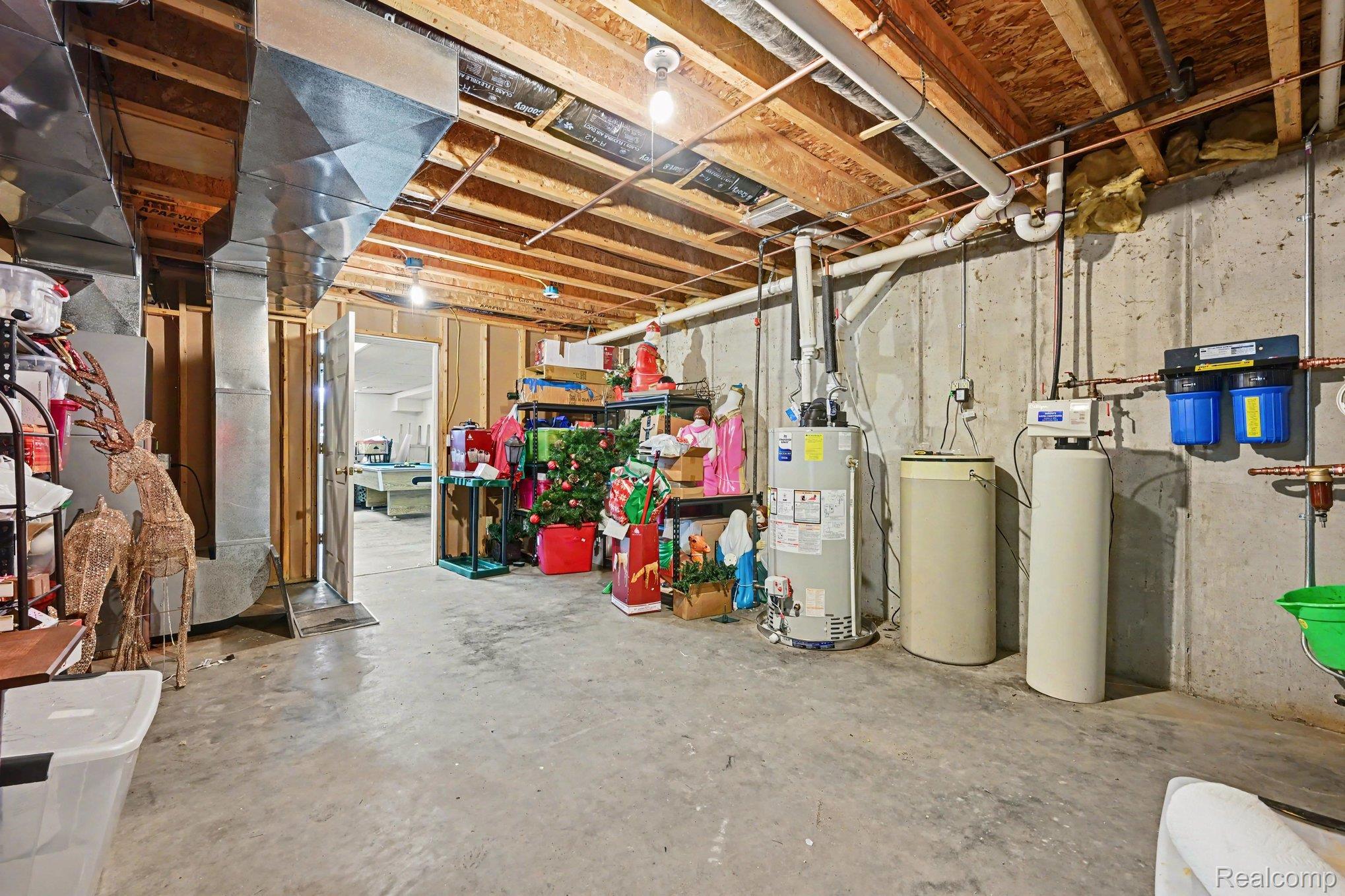 996 Arbogast Road Union City, MI 49094 - Photo 20 of 34 Unfinished basement space with exposed wooden joists and concrete flooring
