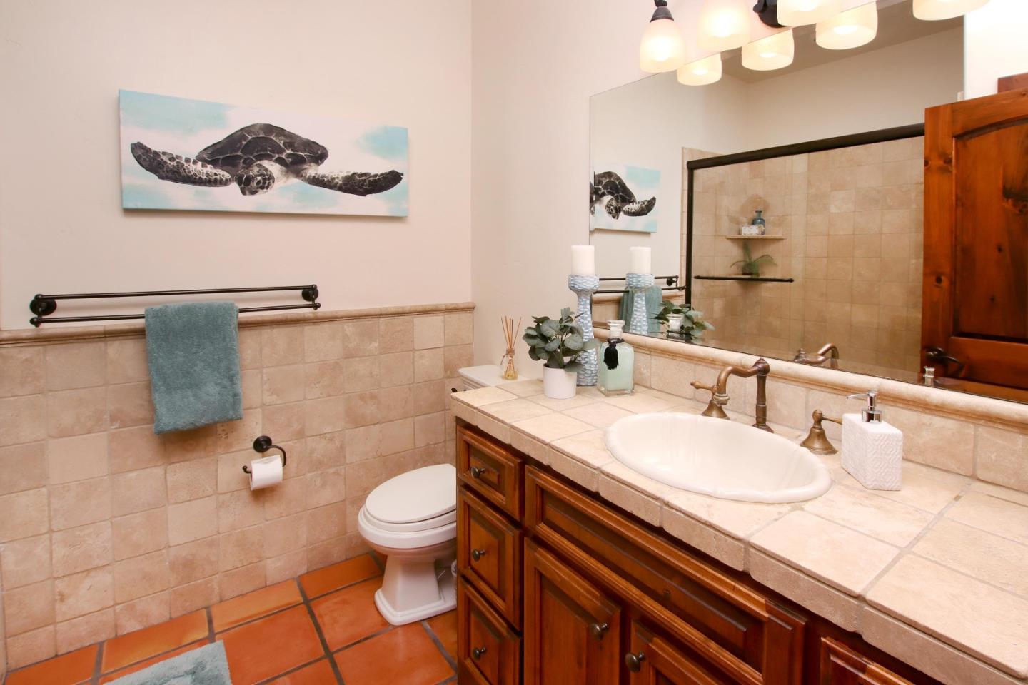 107 Beachgate Way Aptos, CA 95003 - Photo 26 of 95 a bathroom with a sink a toilet and a mirror