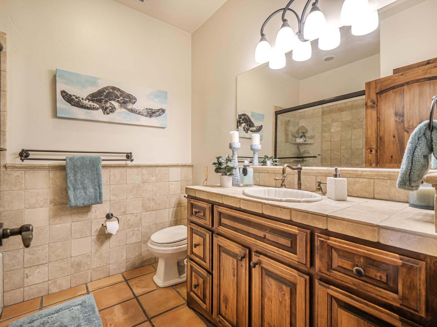 107 Beachgate Way Aptos, CA 95003 - Photo 84 of 95 a bathroom with a sink a toilet and a mirror