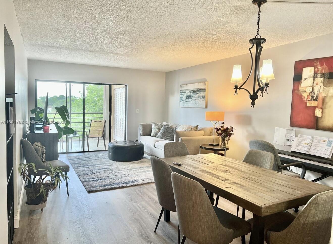 9235 Southwest 8th Street, Unit 507 Boca Raton, FL 33428 - Photo 1 of 16 a living room with furniture two window and wooden floor