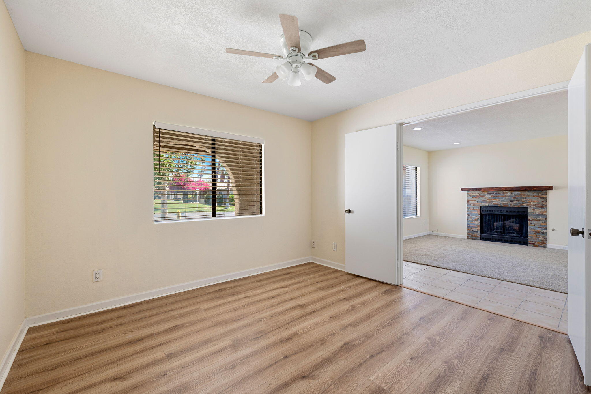 41885 Largo Palm Desert, CA 92211 - Photo 12 of 26 an empty room with windows and a fireplace