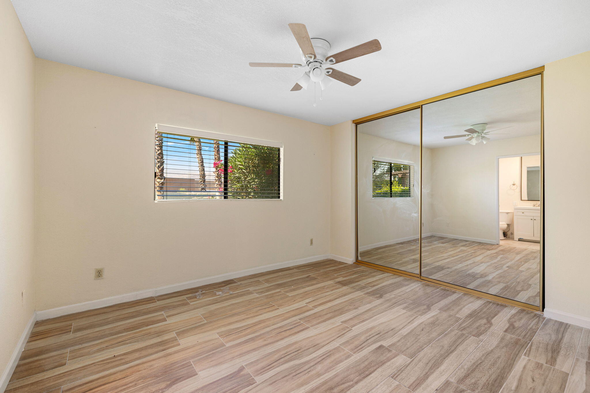 41885 Largo Palm Desert, CA 92211 - Photo 13 of 26 a view of an empty room with window and wooden floor
