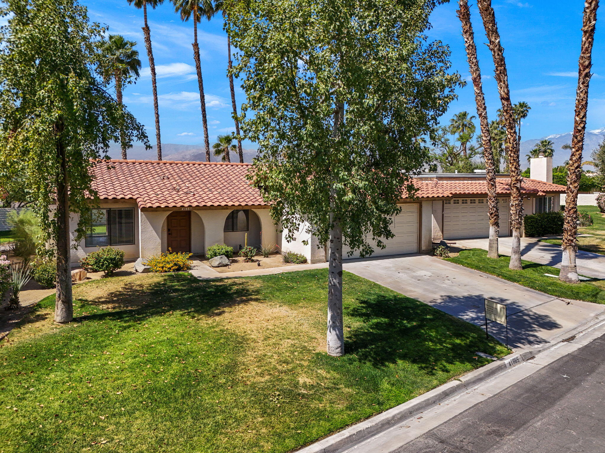 41885 Largo Palm Desert, CA 92211 - Photo 2 of 26 a view of a house with garden and trees