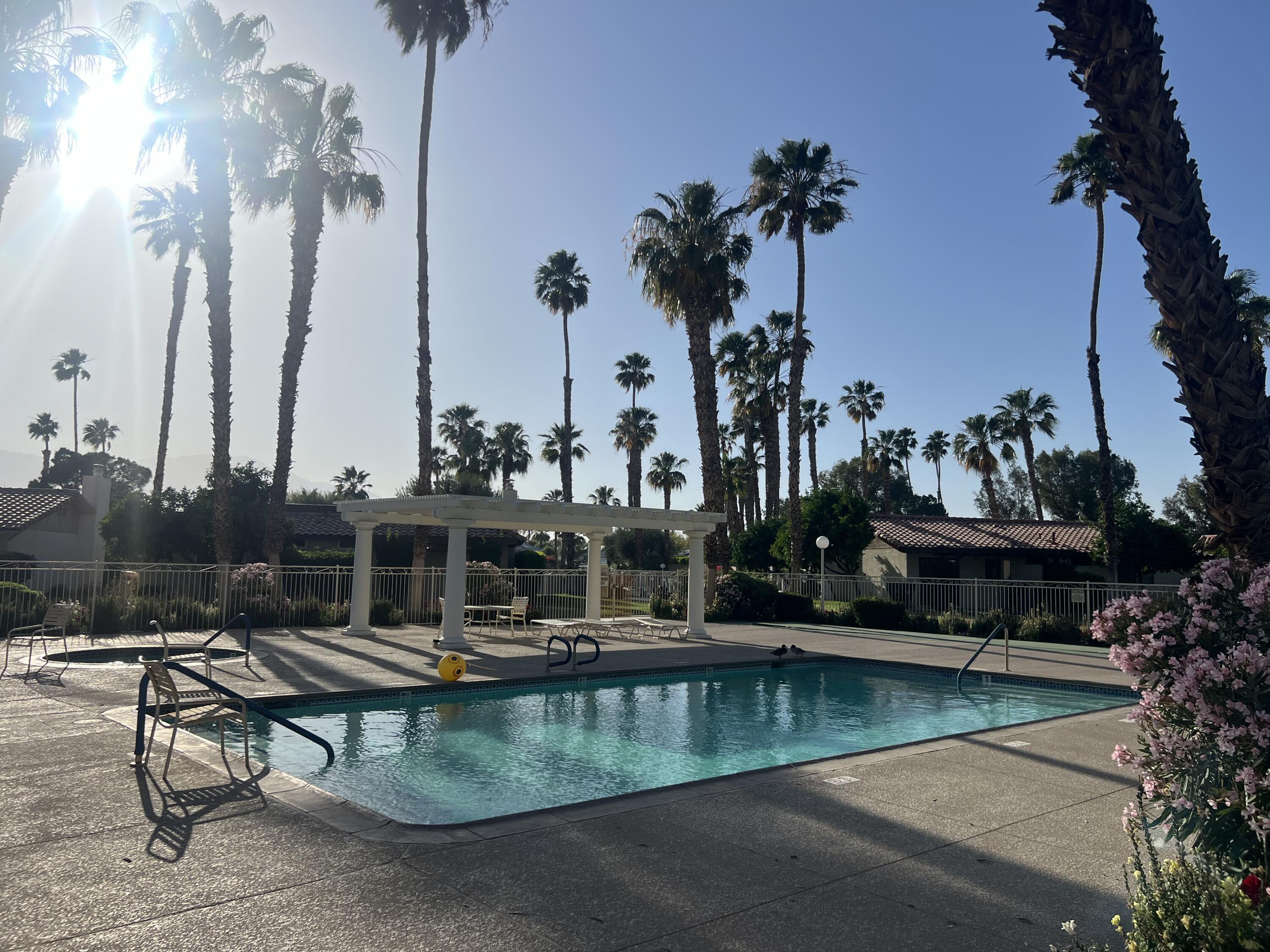 41885 Largo Palm Desert, CA 92211 - Photo 25 of 26 a view of a swimming pool with a table and chairs