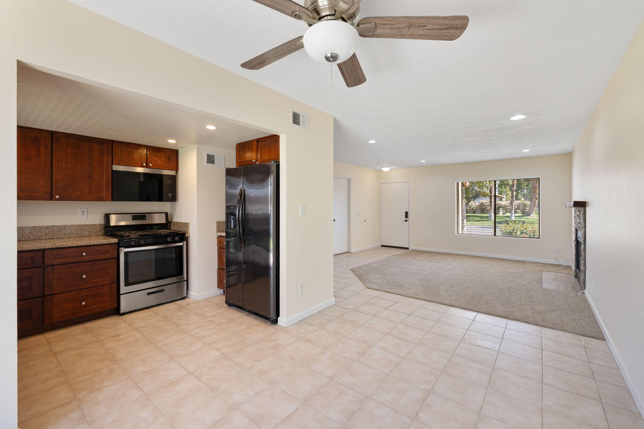 41885 Largo Palm Desert, CA 92211 - Photo 8 of 26 a view of kitchen with stainless steel appliances kitchen island granite countertop a refrigerator and a stove top oven