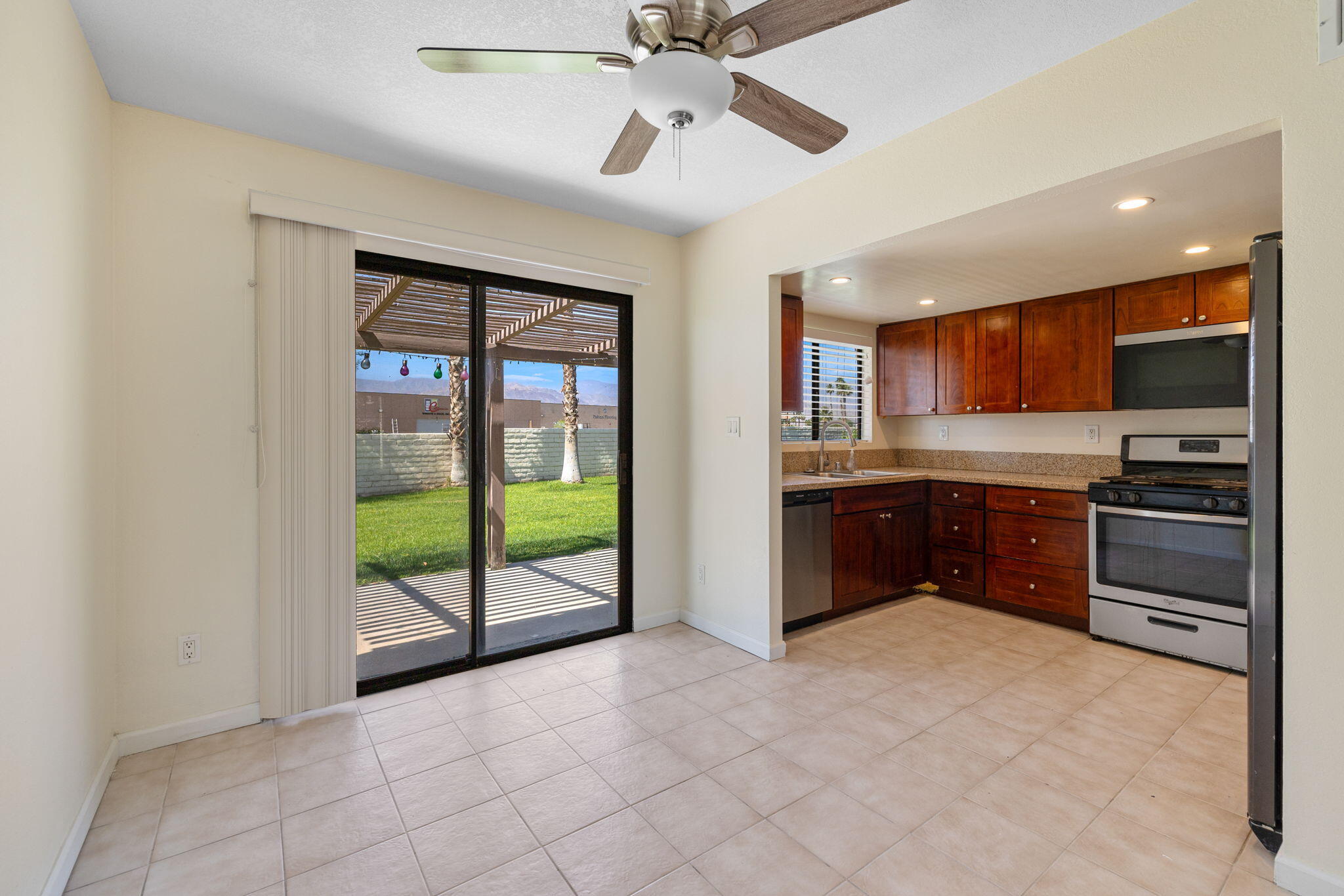 41885 Largo Palm Desert, CA 92211 - Photo 9 of 26 a kitchen with stainless steel appliances granite countertop a refrigerator and a stove top oven