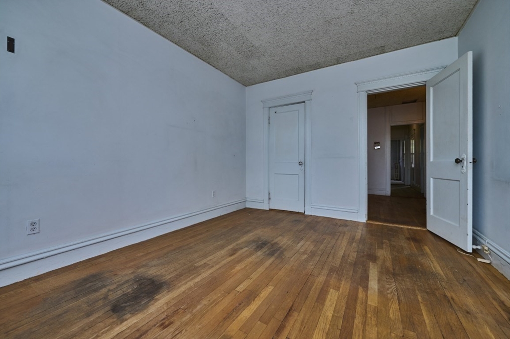 386 Riverway, Unit 4 Boston, MA 02115 - Photo 11 of 14 a view of an empty room and wooden floor
