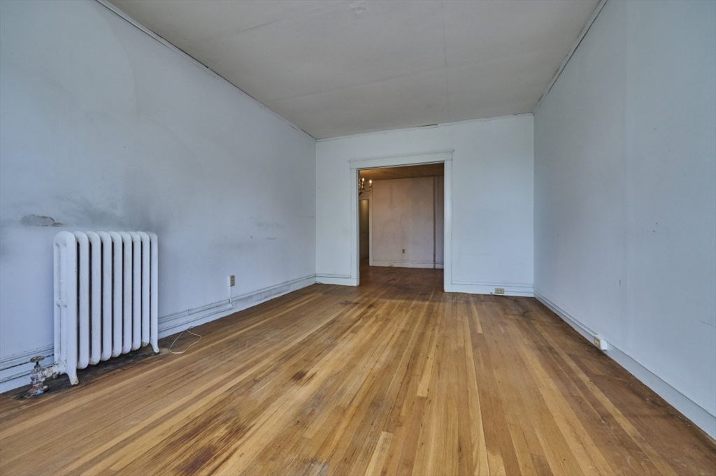 386 Riverway, Unit 4 Boston, MA 02115 - Photo 3 of 14 a view of a room with wooden floor and fence