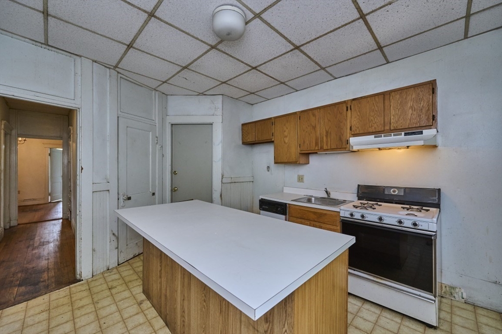 386 Riverway, Unit 4 Boston, MA 02115 - Photo 7 of 14 a kitchen that has a cabinets and a stove