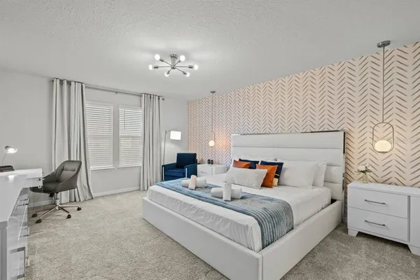 a bedroom with bed and a chandelier