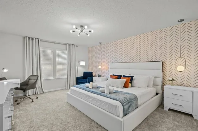 a bedroom with bed and a chandelier