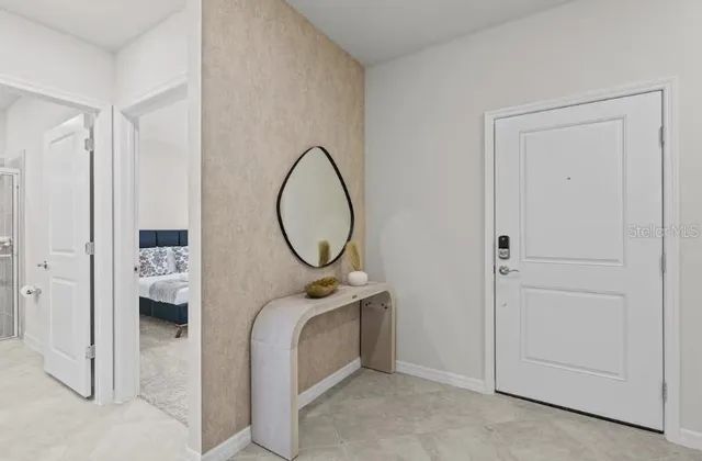 a bedroom with a bed a mirror and a closet