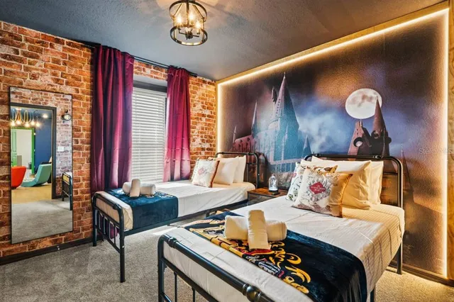 a bedroom with furniture and a large window