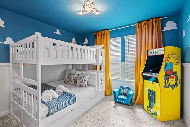 a living room with patio furniture and a chandelier