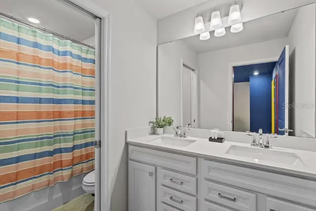 an aerial view of a swimming pool with outdoor seating