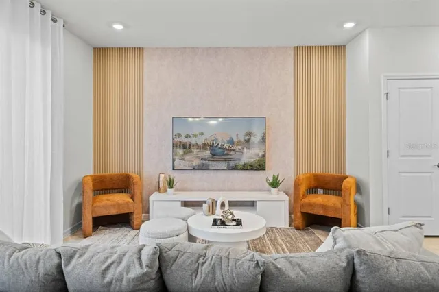 a living room with furniture and a mirror