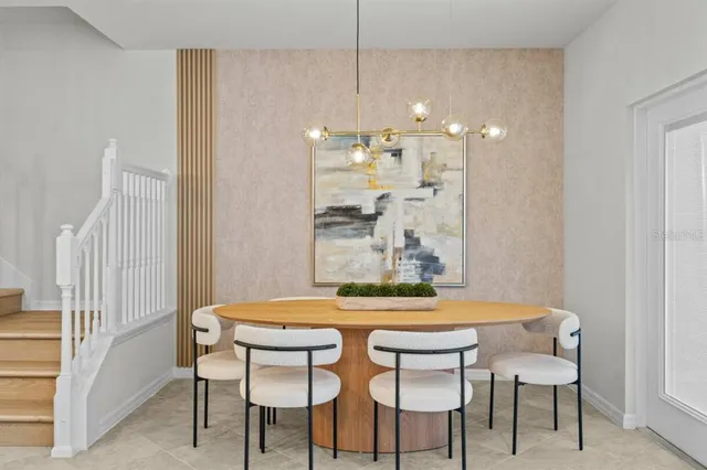 a view of a dining room with furniture and chandelier