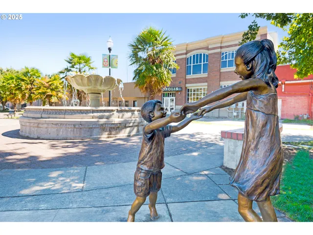a view of a park with iron fence