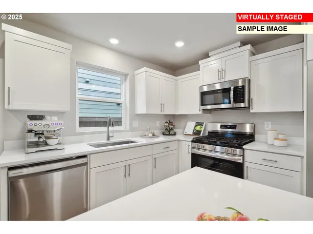 a kitchen with stainless steel appliances granite countertop a sink dishwasher stove top oven and cabinets with wooden floor