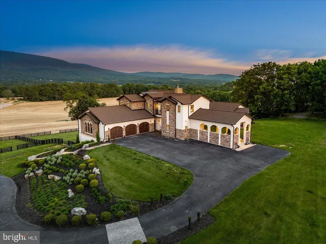 an aerial view of a house with big yard