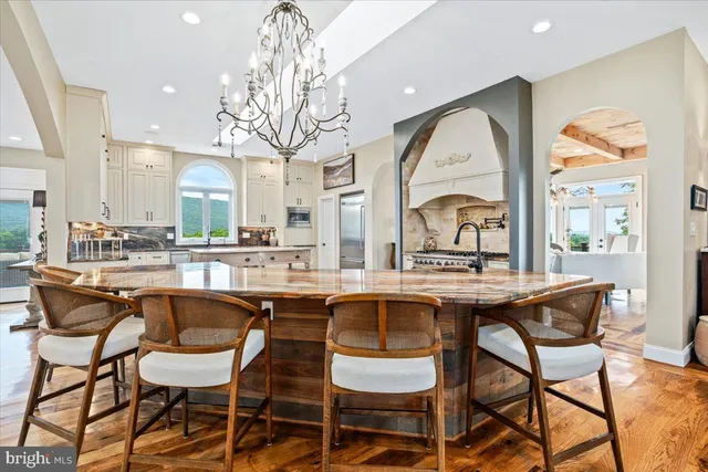 a bedroom with a large bed and wooden floor