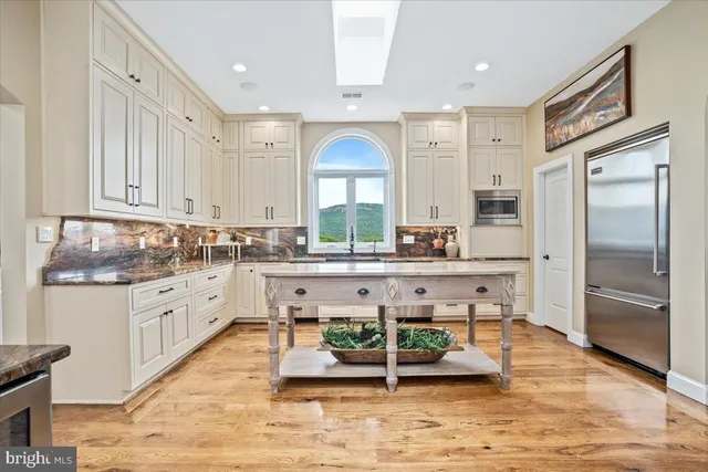 a spacious bathroom with a tub sink and mirror