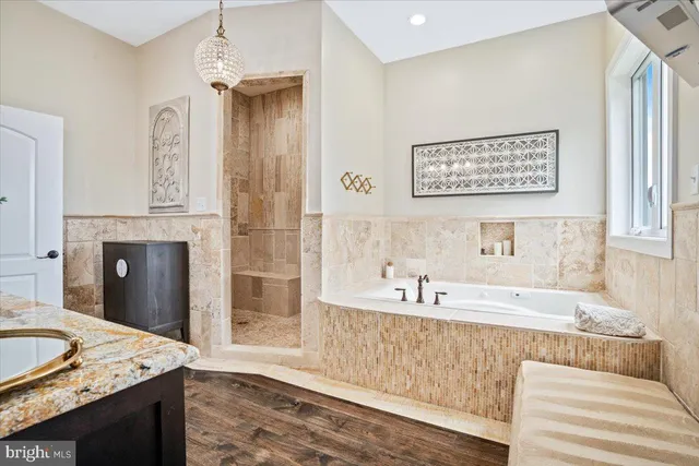 a bathroom with a granite countertop sink and a toilet