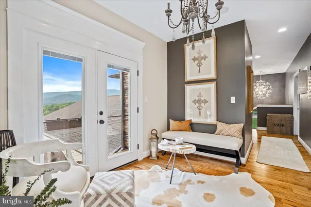 a living room with patio furniture and a large window