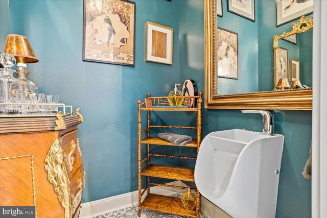 a view of a patio with couches table and chairs with wooden floor and fence