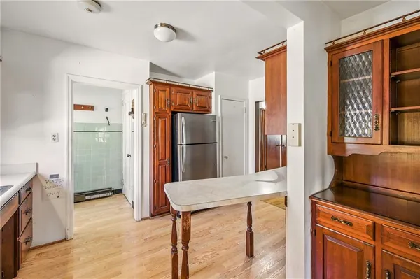 a kitchen with stainless steel appliances kitchen island granite countertop a refrigerator and a stove top oven