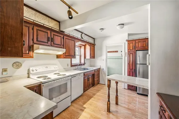 a kitchen with a stove a sink and a refrigerator