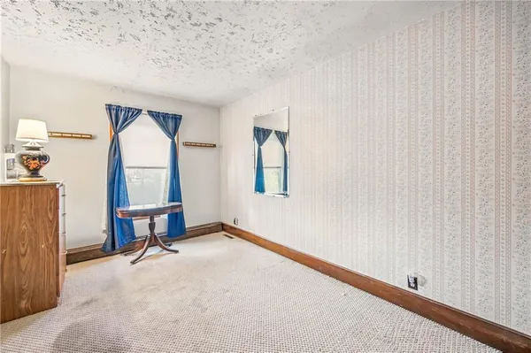 a view of a bedroom with closet and cabinet
