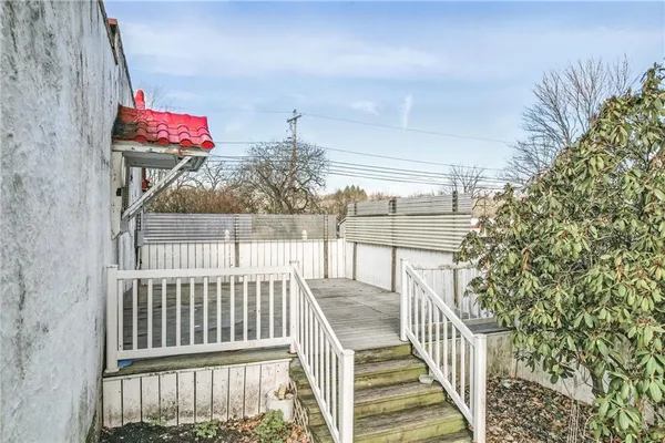 a front view of a house with a garden and plants