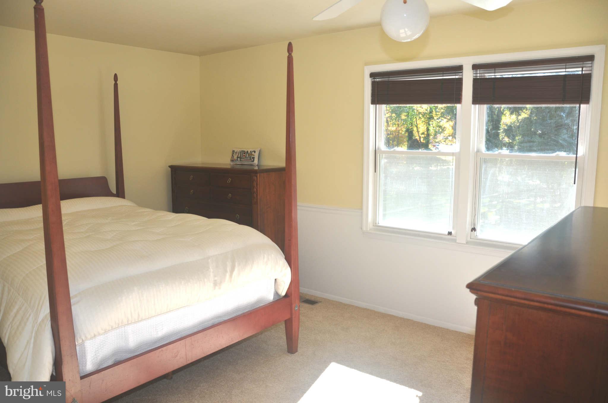 12405 Melmark Court Reston, VA 20191 - Photo 13 of 30 a bed sitting in a bedroom next to a window