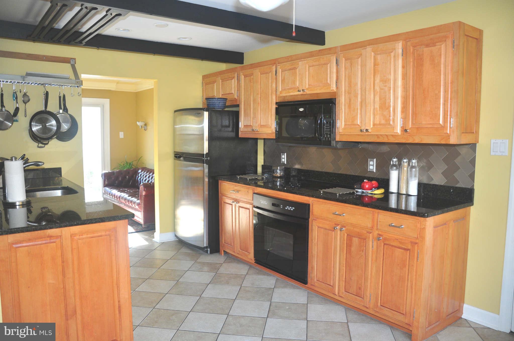12405 Melmark Court Reston, VA 20191 - Photo 6 of 30 a kitchen with stainless steel appliances granite countertop a refrigerator a stove top oven and a sink