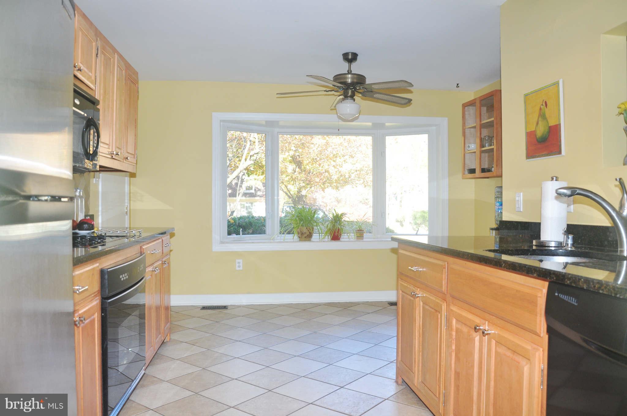 12405 Melmark Court Reston, VA 20191 - Photo 8 of 30 a kitchen with a sink a stove and a window