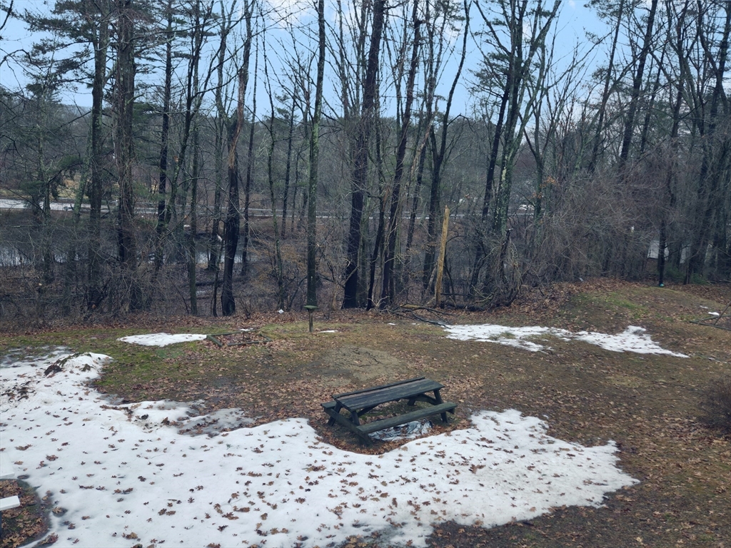 35 Pine Ridge Drive Oxford, MA 01540 - Photo 17 of 19 a view of a yard with trees in the background