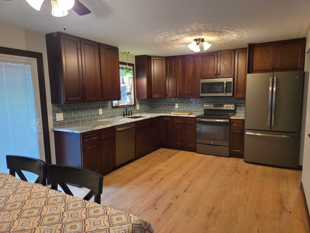 35 Pine Ridge Drive Oxford, MA 01540 - Photo 2 of 19 a kitchen with cabinets a sink and stainless steel appliances