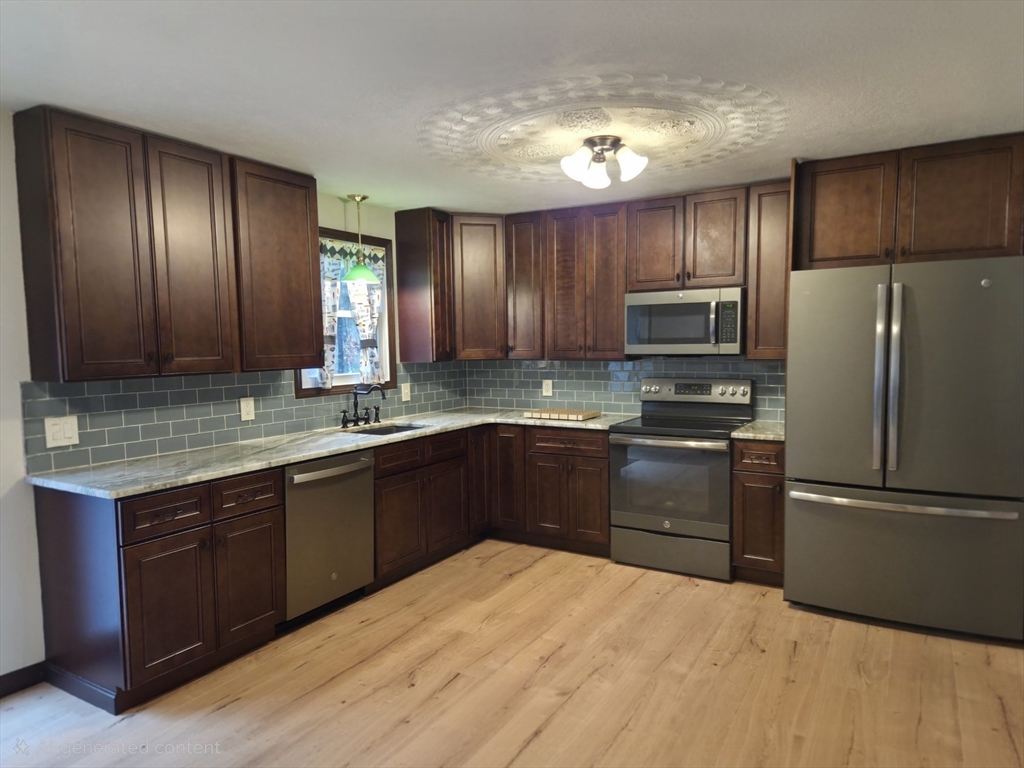 35 Pine Ridge Drive Oxford, MA 01540 - Photo 4 of 19 a kitchen with granite countertop stainless steel appliances and wooden cabinets