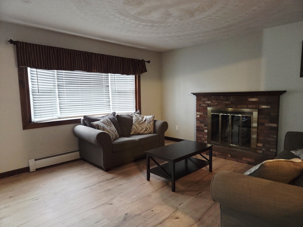 35 Pine Ridge Drive Oxford, MA 01540 - Photo 6 of 19 a living room with furniture and a fireplace