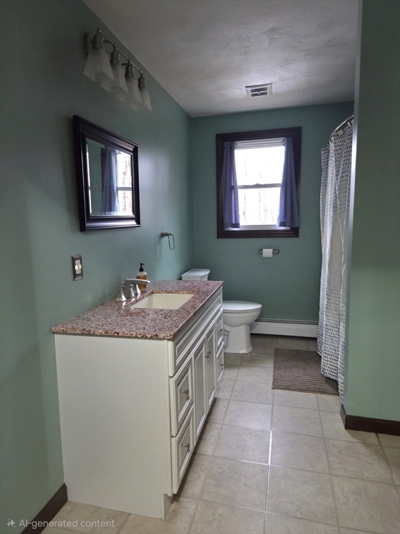 35 Pine Ridge Drive Oxford, MA 01540 - Photo 7 of 19 a bathroom with a granite countertop toilet a sink and a mirror