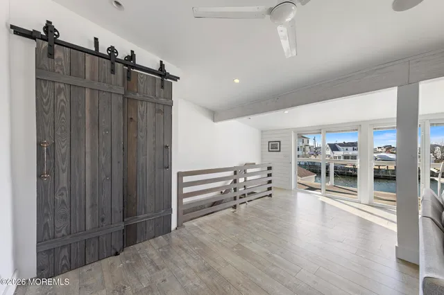 a view of a hallway with wooden floor and furniture