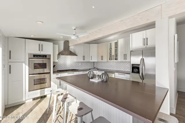 a kitchen with granite countertop a sink stove and refrigerator