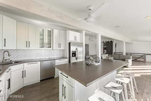a kitchen with center island table and chairs