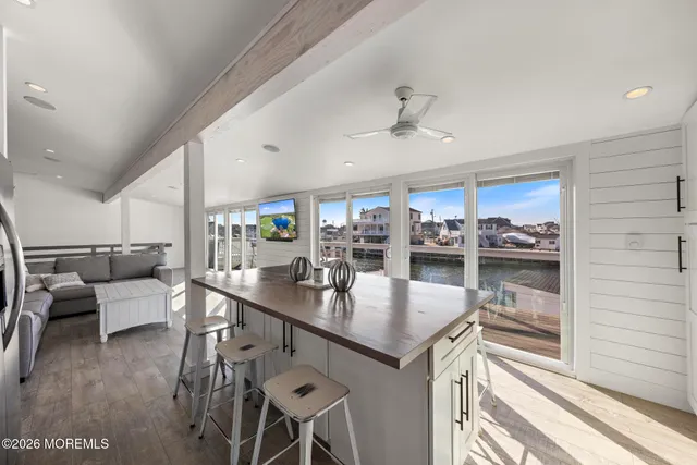 a kitchen with a table chairs and wooden floor