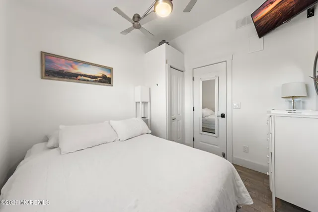 a bedroom with a large bed and a chandelier