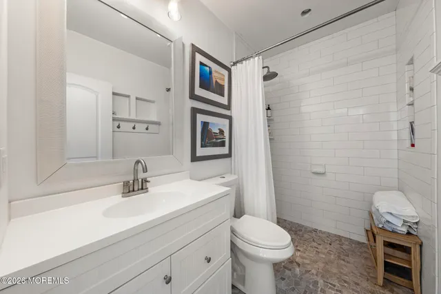 a bathroom with a sink toilet and shower