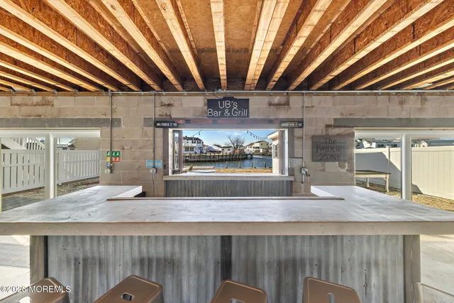 a living room with stainless steel appliances granite countertop furniture and fireplace