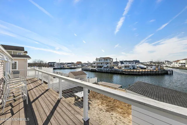a view of an ocean with boats and trees in the background